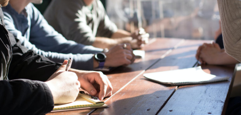 group of people taking notes