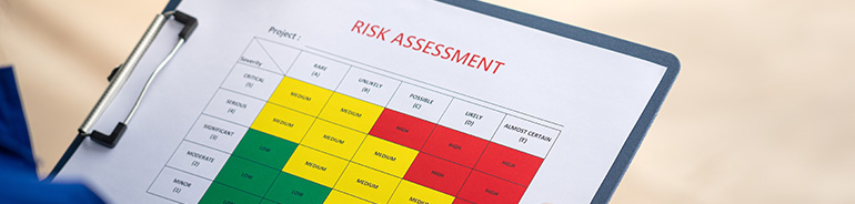 risk assessment matrix document on a click board